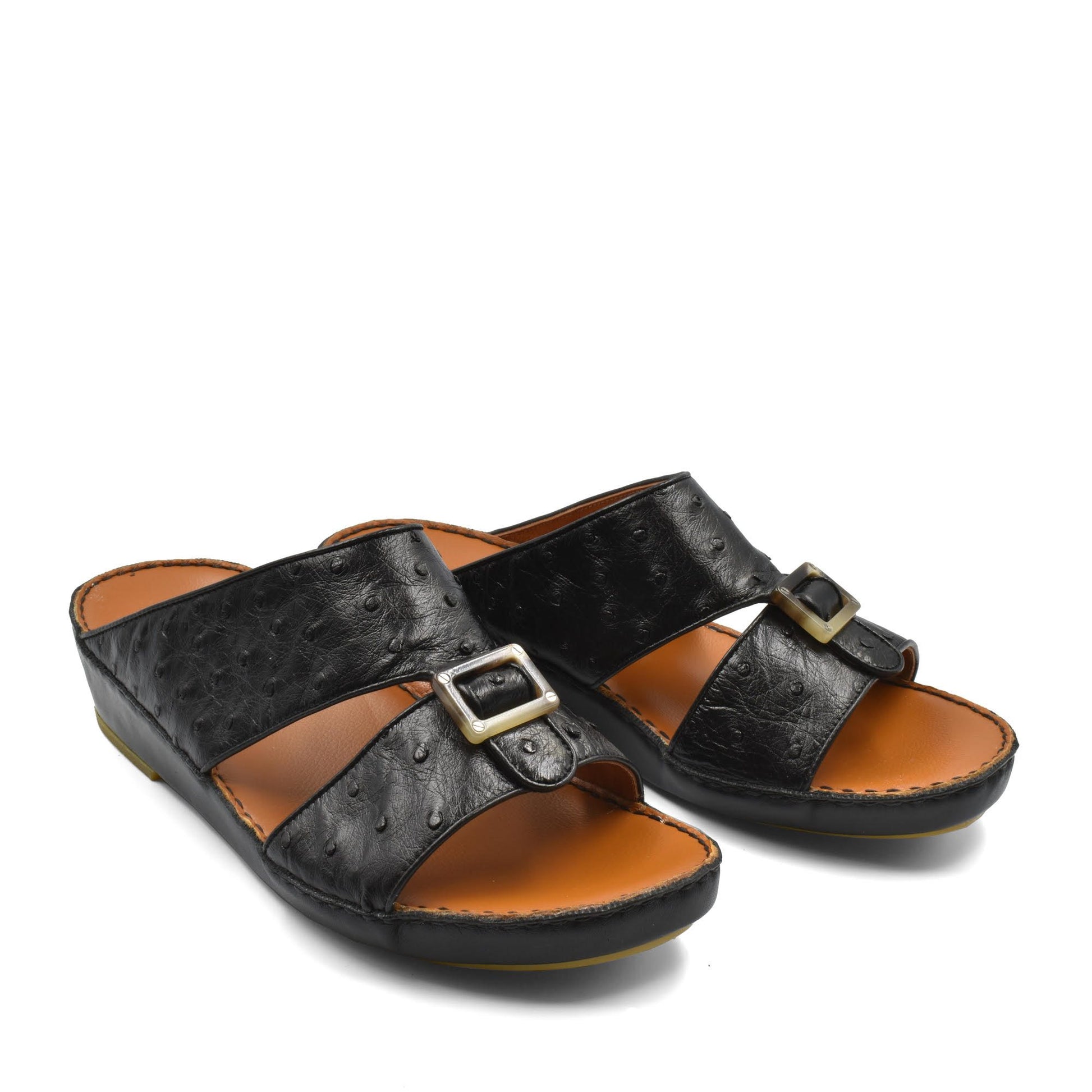 Black ostrich leather sandals with buckle detail and cushioned tan footbed