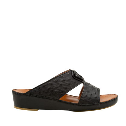 Black ostrich leather sandals with cushioned tan footbed and low wedge heel side view