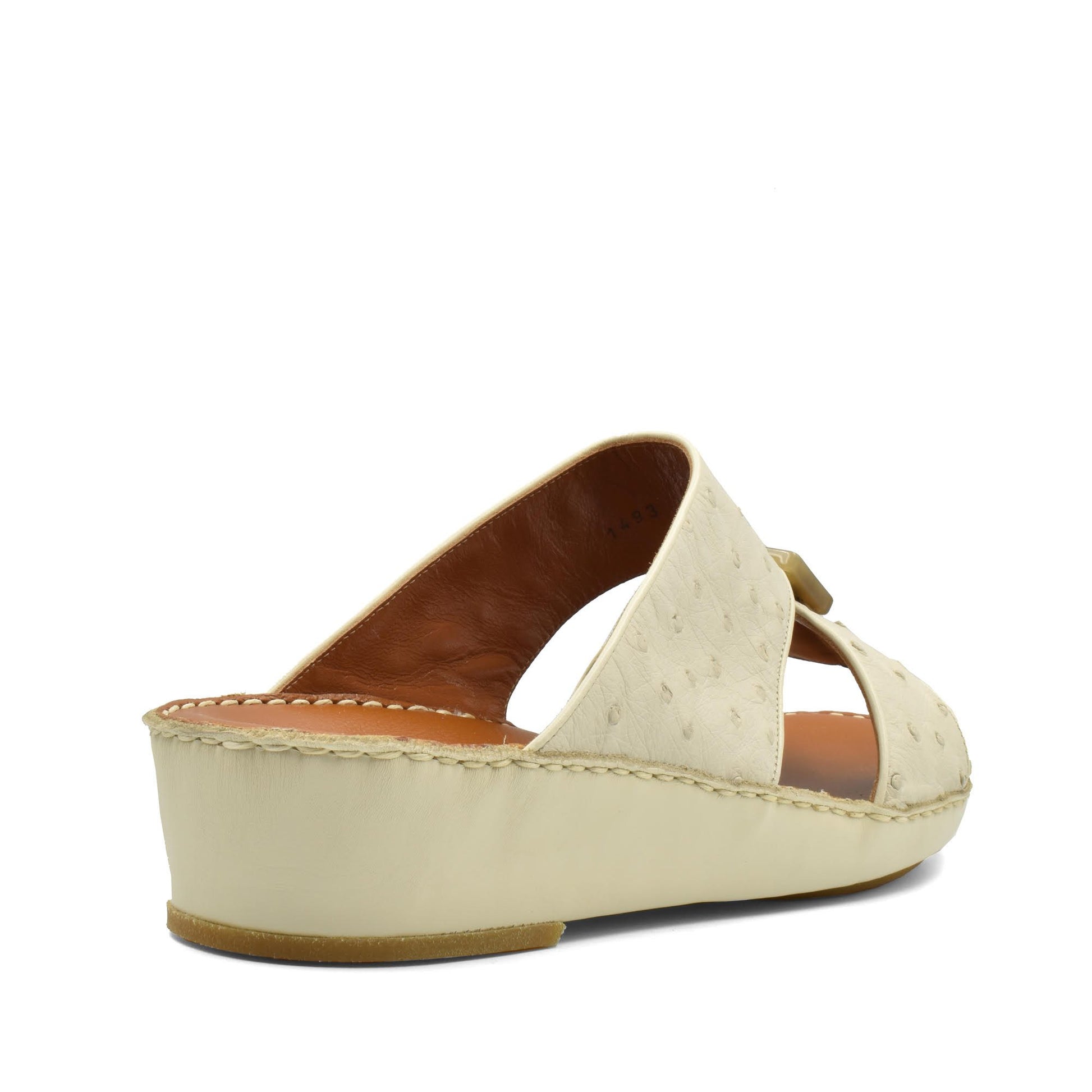 Cream-colored ostrich leather sandals with wedge heel and open toe design from Private Collection