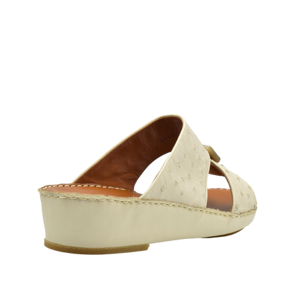 Cream-colored ostrich leather sandals with wedge heel and open toe design from Private Collection