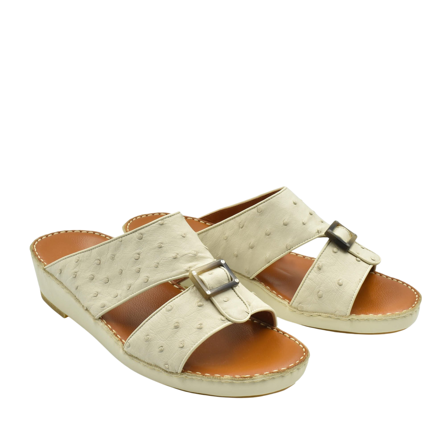 Beige ostrich leather sandals with buckle detail and cushioned tan footbed for comfort