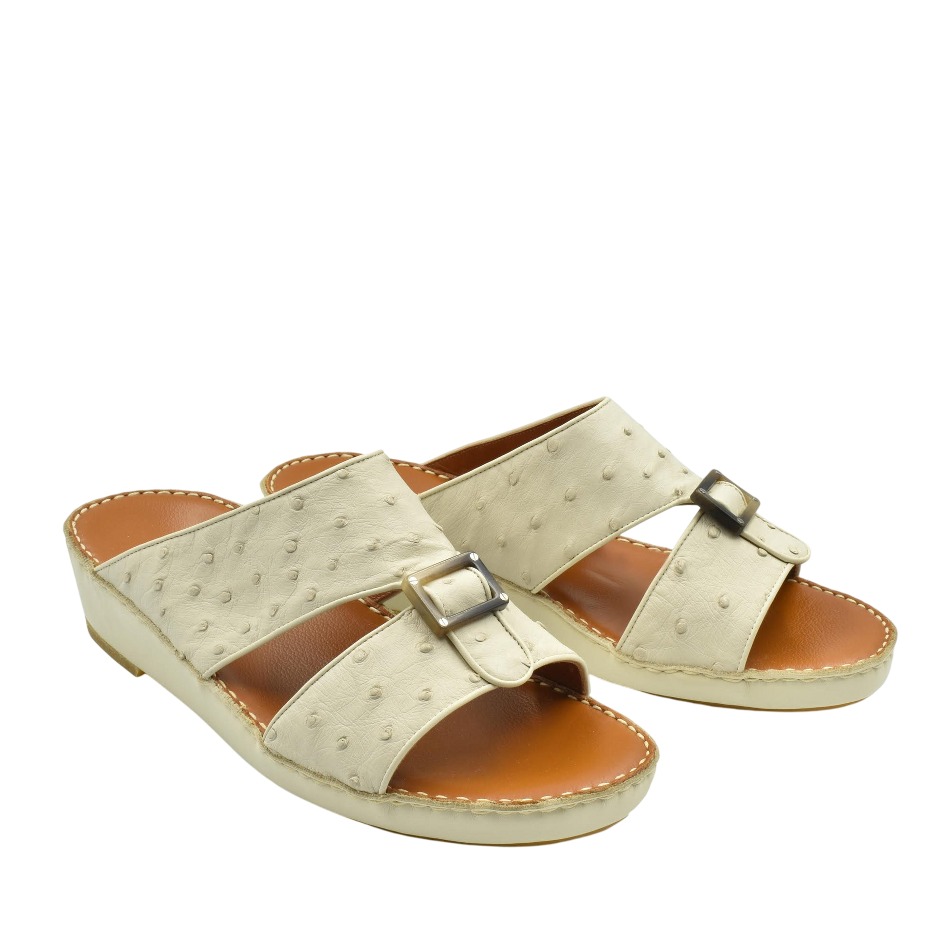 Beige ostrich leather sandals with buckle detail and cushioned tan footbed for comfort