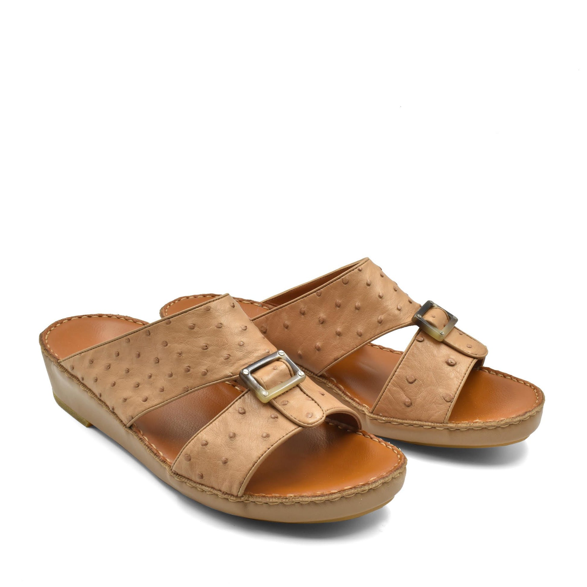 Tan ostrich leather sandals with buckle straps and cushioned soles for comfortable wear