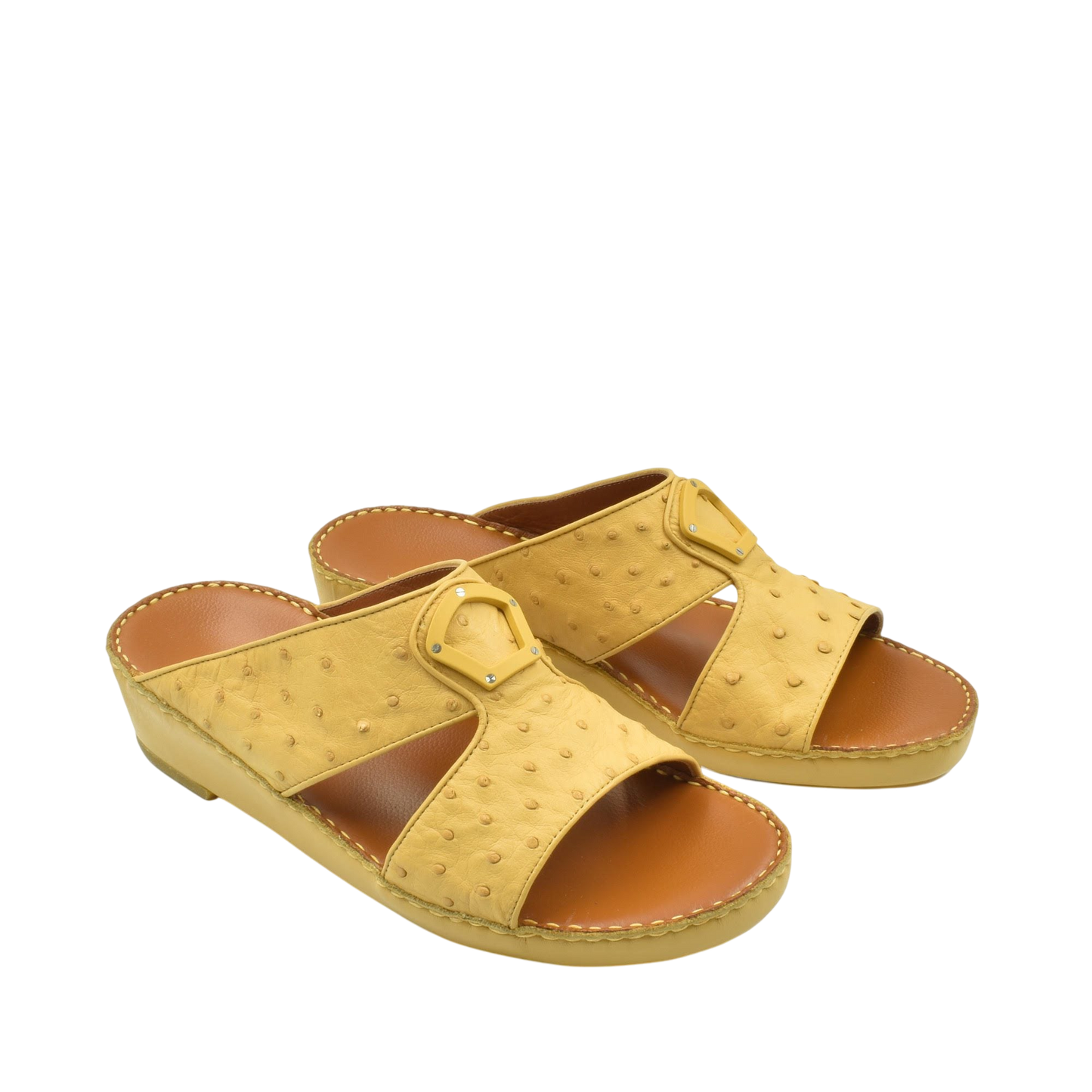 Yellow ostrich leather sandals with open toe and buckle detail on a white background