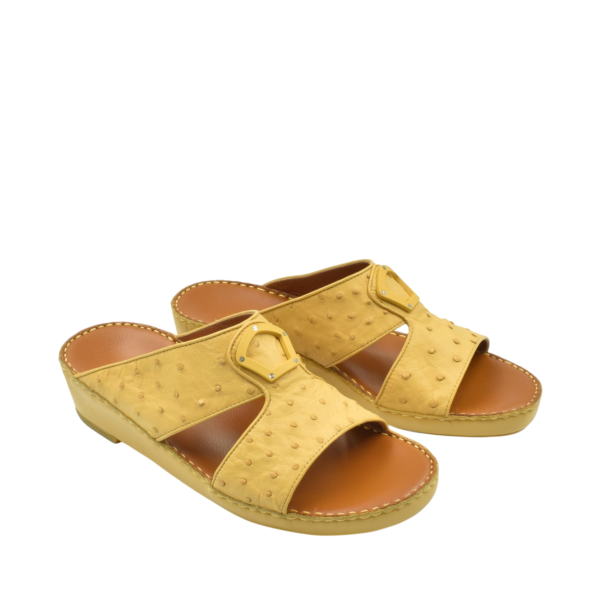 Yellow ostrich leather sandals with open toe and buckle detail on a white background