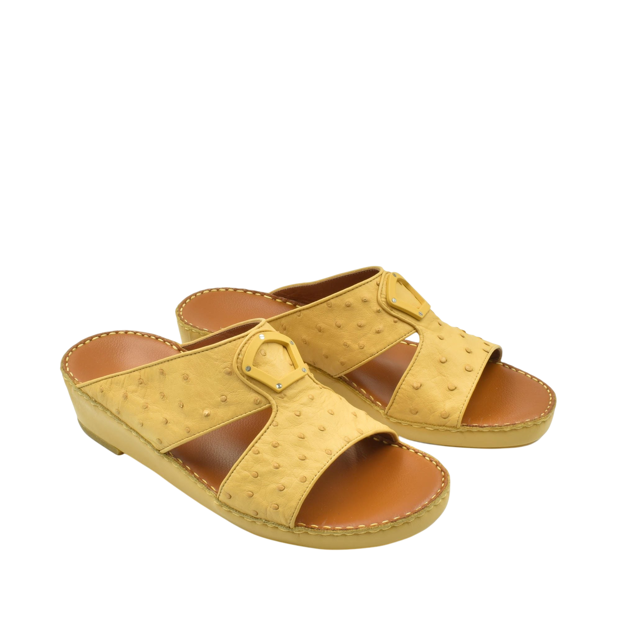 Yellow ostrich leather sandals with open toe and buckle detail on a white background