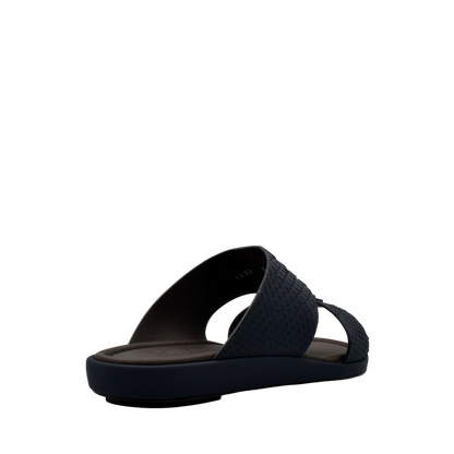 Black slip-on sandals featuring textured python skin footwear design with cushioned sole