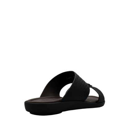 Black slip-on sandal from private collection showcasing sleek python skin footwear design