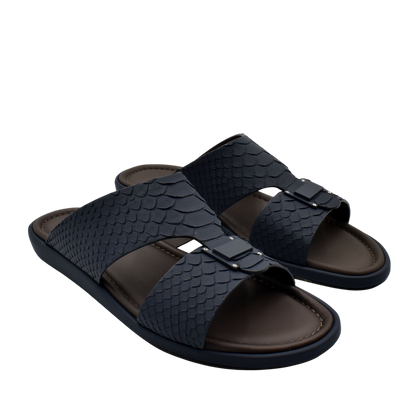 Black python skin footwear slides with textured straps and comfortable brown footbed