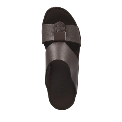 Top view of brown Quadratura Isola Lustre sandals with crisscross leather straps and metal buckle