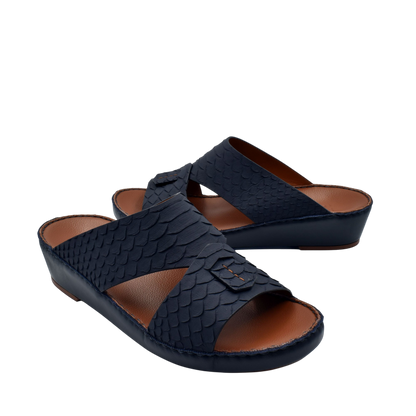 Black rubber python shoes with textured scale pattern and open toe design on brown insole