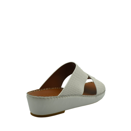 White slip-on rubber python shoes with a low wedge heel and textured upper from Private Collection