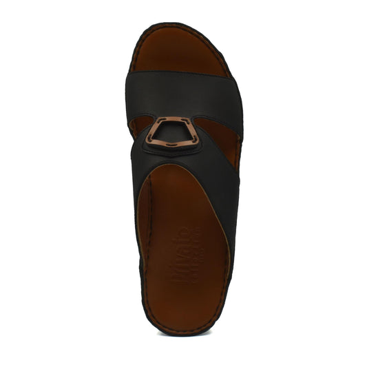 Top view of Rubbercalf contrast shoes in black with brown sole and decorative buckle detail