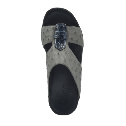 Top view of gray ostrich leather sandals with black sole and detailed strap design
