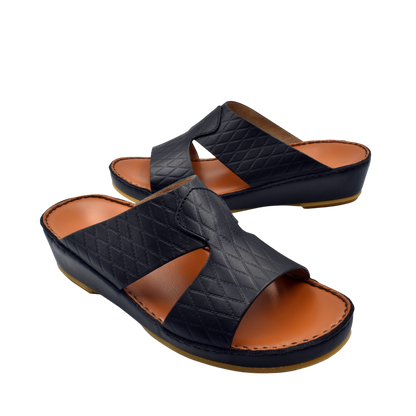 Black Western style leather sandals with quilted straps and cushioned tan footbed
