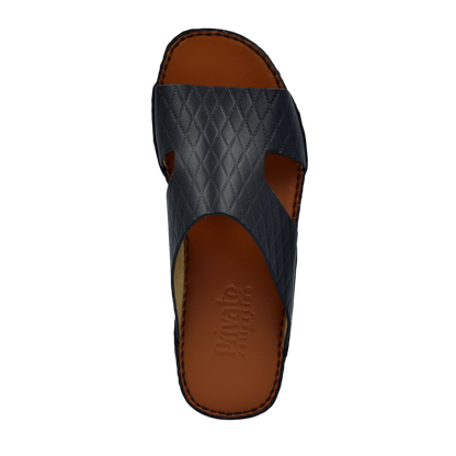 Black Western style leather sandals with quilted straps and brown cushioned footbed